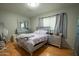 Elegant bedroom with shiny silver furniture, mirrored dresser, and a comfortable bed with soft, light purple bedding at 1412 W 7Th Pl, Tempe, AZ 85281