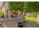 Manicured backyard with patio, lake view, mature trees and gravel at 1575 S Pennington Dr, Chandler, AZ 85286