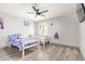 Charming bedroom features two twin beds, ceiling fan, and wood-look flooring at 1575 S Pennington Dr, Chandler, AZ 85286