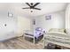 This bedroom features two twin beds, closet, ceiling fan and wood-look flooring at 1575 S Pennington Dr, Chandler, AZ 85286