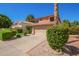 Charming two-story home with a terra cotta roof, flowering bushes, and a two car garage at 1575 S Pennington Dr, Chandler, AZ 85286