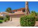 Charming two-story home with a terra cotta roof, flowering bushes, and a two car garage at 1575 S Pennington Dr, Chandler, AZ 85286