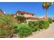 Charming two-story home with a terra cotta roof, flowering bushes, and manicured lawn at 1575 S Pennington Dr, Chandler, AZ 85286