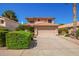 Charming two-story home with a terra cotta roof, flowering bushes, and a two car garage at 1575 S Pennington Dr, Chandler, AZ 85286