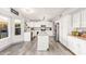 Modern kitchen with white cabinets, an island, stainless steel appliances, and sleek flooring at 1575 S Pennington Dr, Chandler, AZ 85286