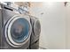 Modern laundry room with front-load washer and dryer at 1575 S Pennington Dr, Chandler, AZ 85286