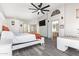 Spacious main bedroom featuring a modern ceiling fan, wood floors, and an en suite bathroom at 1575 S Pennington Dr, Chandler, AZ 85286