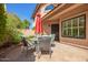 Inviting outdoor patio with stone flooring, dining table set, red umbrella, and garden views at 1575 S Pennington Dr, Chandler, AZ 85286
