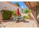 Inviting outdoor patio with stone flooring, dining table set, and garden views at 1575 S Pennington Dr, Chandler, AZ 85286