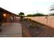 Private backyard featuring a patio, rock landscaping, and a mature palm tree at 16011 N 35Th Dr, Phoenix, AZ 85053