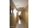 Inviting hallway featuring neutral walls and tile flooring at 16011 N 35Th Dr, Phoenix, AZ 85053