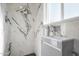 Bathroom featuring a modern vanity and a walk-in shower with beautiful marble tile at 1613 W Flower N Cir, Phoenix, AZ 85015