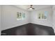 Bright bedroom with hardwood floors and large windows overlooking the neighborhood at 1613 W Flower N Cir, Phoenix, AZ 85015