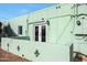 Exterior view of home with green paint and a small raised patio at 1613 W Flower N Cir, Phoenix, AZ 85015