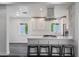 Open kitchen layout with an island cooktop and barstool seating at 1613 W Flower N Cir, Phoenix, AZ 85015