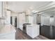 Open-concept kitchen with white cabinets and stainless steel appliances at 1613 W Flower N Cir, Phoenix, AZ 85015