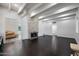 Spacious living room featuring wood floors, white beams, and a fireplace at 1613 W Flower N Cir, Phoenix, AZ 85015