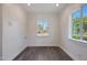 Bright room with dark wood-look flooring and dual-paned windows at 1613 W Flower N Cir, Phoenix, AZ 85015
