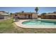 Backyard featuring a refreshing pool with tanning ledges, and a grassy area at 17232 N 29Th Ave, Phoenix, AZ 85053