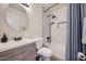 Bathroom featuring a modern sink and toilet with a shower/bathtub combo with decorative tiled walls at 17232 N 29Th Ave, Phoenix, AZ 85053