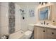 Modern bathroom features updated sink, shower with black fixtures and a decorative, artistic tile accent wall at 17232 N 29Th Ave, Phoenix, AZ 85053