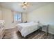 Cozy bedroom featuring a ceiling fan, wood-look floors, and natural light at 17232 N 29Th Ave, Phoenix, AZ 85053