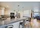 Bright kitchen with stainless appliances, breakfast bar and view to the living room at 17232 N 29Th Ave, Phoenix, AZ 85053