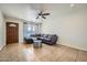 Comfortable living room featuring tile floors, fan and a cozy sectional couch at 17232 N 29Th Ave, Phoenix, AZ 85053