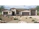 Stunning single-story home featuring a three-car garage and desert landscaping at 18130 E Silver Creek Ln, Queen Creek, AZ 85142