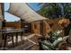 Backyard patio with shade cover featuring outdoor seating and a bar area at 1849 S Balboa Dr, Gilbert, AZ 85295