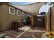 Backyard patio with shade cover featuring outdoor seating and a stainless-steel barbecue grill at 1849 S Balboa Dr, Gilbert, AZ 85295