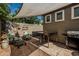 Backyard patio with shade cover features outdoor seating and a stainless-steel barbecue grill at 1849 S Balboa Dr, Gilbert, AZ 85295