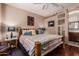 Bright bedroom featuring wood beam bed frame, hardwood floors, and natural light from large windows at 1849 S Balboa Dr, Gilbert, AZ 85295