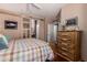 Bedroom featuring wood beam bed frame, hardwood floors, and an ensuite bathroom at 1849 S Balboa Dr, Gilbert, AZ 85295