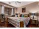 Bright bedroom with a ceiling fan, hardwood floors, and natural light from a large window at 1849 S Balboa Dr, Gilbert, AZ 85295