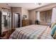 Bedroom with a ceiling fan, hardwood floors, and closet access at 1849 S Balboa Dr, Gilbert, AZ 85295