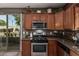 Traditional kitchen with stainless steel appliances, granite countertops, and backyard access at 1849 S Balboa Dr, Gilbert, AZ 85295