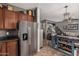 Spacious kitchen featuring stainless steel refrigerator, island, and an open layout to the living area at 1849 S Balboa Dr, Gilbert, AZ 85295