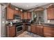 Traditional kitchen featuring stainless steel appliances, granite countertops, and custom cabinetry at 1849 S Balboa Dr, Gilbert, AZ 85295