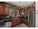 Traditional kitchen featuring stainless steel appliances, granite countertops, and tile flooring at 1849 S Balboa Dr, Gilbert, AZ 85295