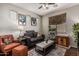Cozy living room featuring a comfortable gray sofa, a plush orange armchair, and natural light from a window at 1849 S Balboa Dr, Gilbert, AZ 85295