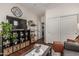 Cozy living room features dark hardwood floors, decorative shelving, and a large clock at 1849 S Balboa Dr, Gilbert, AZ 85295