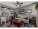 Cozy living room with stylish decor, ceiling fan, and decorative shelving at 1849 S Balboa Dr, Gilbert, AZ 85295