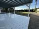 A covered back patio with patterned tile and a large grassy backyard at 1930 W Missouri Ave, Phoenix, AZ 85015