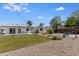 Expansive backyard with lush lawn, gravel area, and outdoor seating, perfect for relaxation and recreation at 1930 W Missouri Ave, Phoenix, AZ 85015