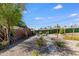 Landscaped backyard with a gravel pathway leading to outdoor seating around a fire pit at 1930 W Missouri Ave, Phoenix, AZ 85015
