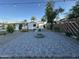 Charming backyard featuring a brick firepit, lovely landscaping, and updated patio at 1930 W Missouri Ave, Phoenix, AZ 85015
