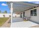 Covered patio with patterned tile, seating, and access to the yard at 1930 W Missouri Ave, Phoenix, AZ 85015