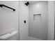 Modern tiled shower with a rain showerhead, built-in niche, and crisp, clean design at 1930 W Missouri Ave, Phoenix, AZ 85015