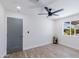 Bright bedroom with light-colored wood floors, modern ceiling fan, and window view at 1930 W Missouri Ave, Phoenix, AZ 85015